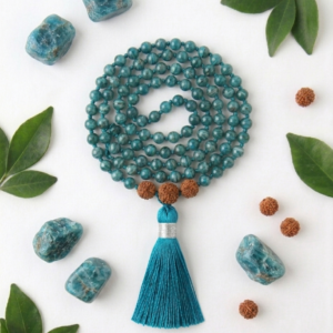 "Handcrafted 108-bead mala necklace made of vibrant blue-green Apatite gemstones featuring a flowing teal tassel, displayed on a neutral background."